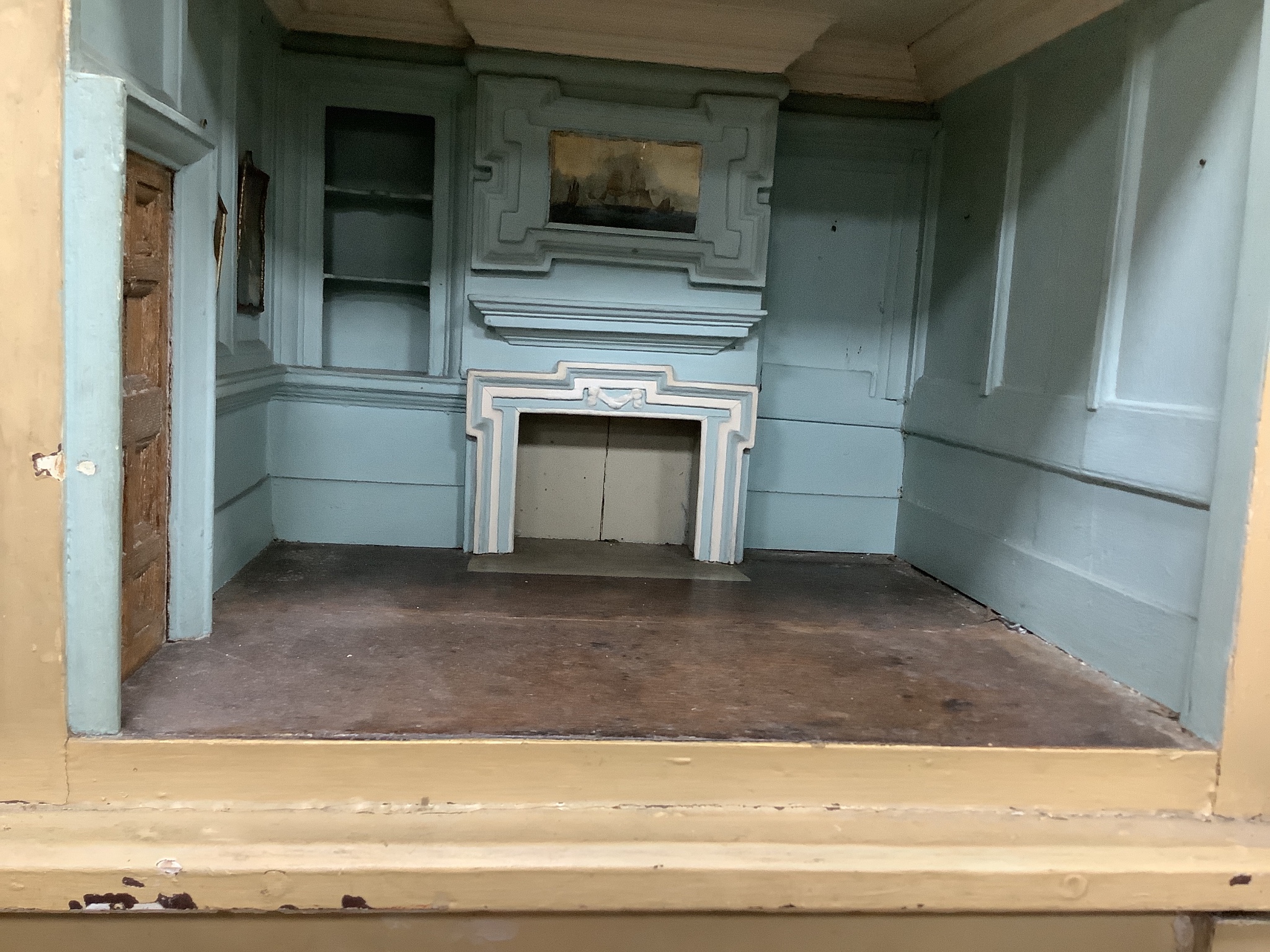 An early 19th century painted doll's house with block work facade enclosing a four room interior with central staircase, to be sold with assorted later furniture and accessories, width 117cm, depth 48cm, height with asso